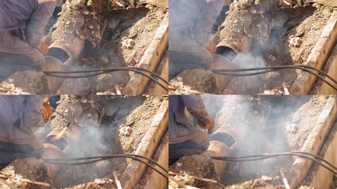 男焊工焊接加热管。管道修复。