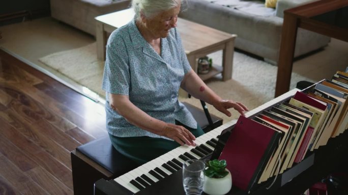 80年代，一位快乐的老奶奶在家里练习钢琴后关上钢琴