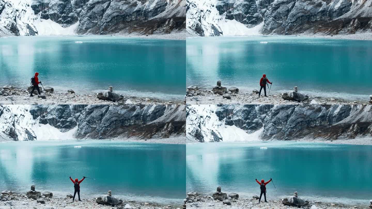 一个人站在山间湖泊前的悬崖边上