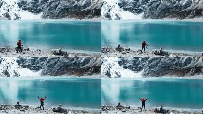 一个人站在山间湖泊前的悬崖边上