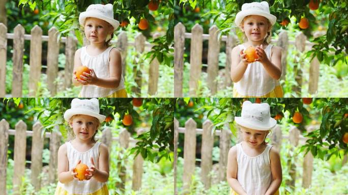 土耳其，小女孩在阳光明媚的橘子树花园里采摘新鲜成熟的橙子