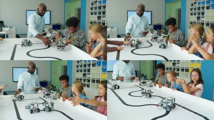 不同的孩子和老师看着电动机器人在桌子上移动