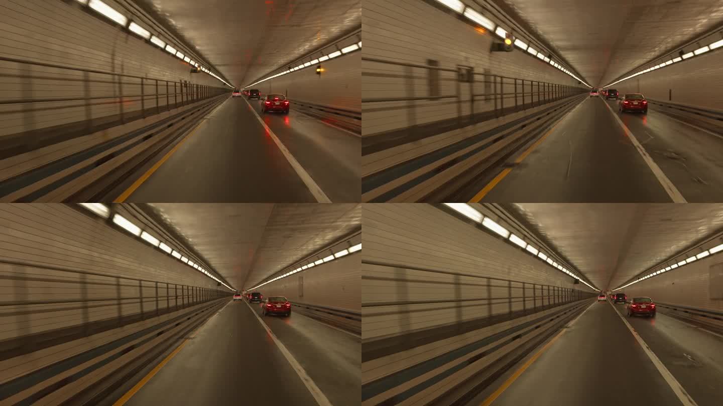 汉普顿路的隧道，远处有车灯。驾驶牌照，POV汽车司机
