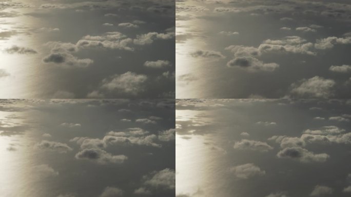 从飞机窗口看晨景，在云层之上飞翔