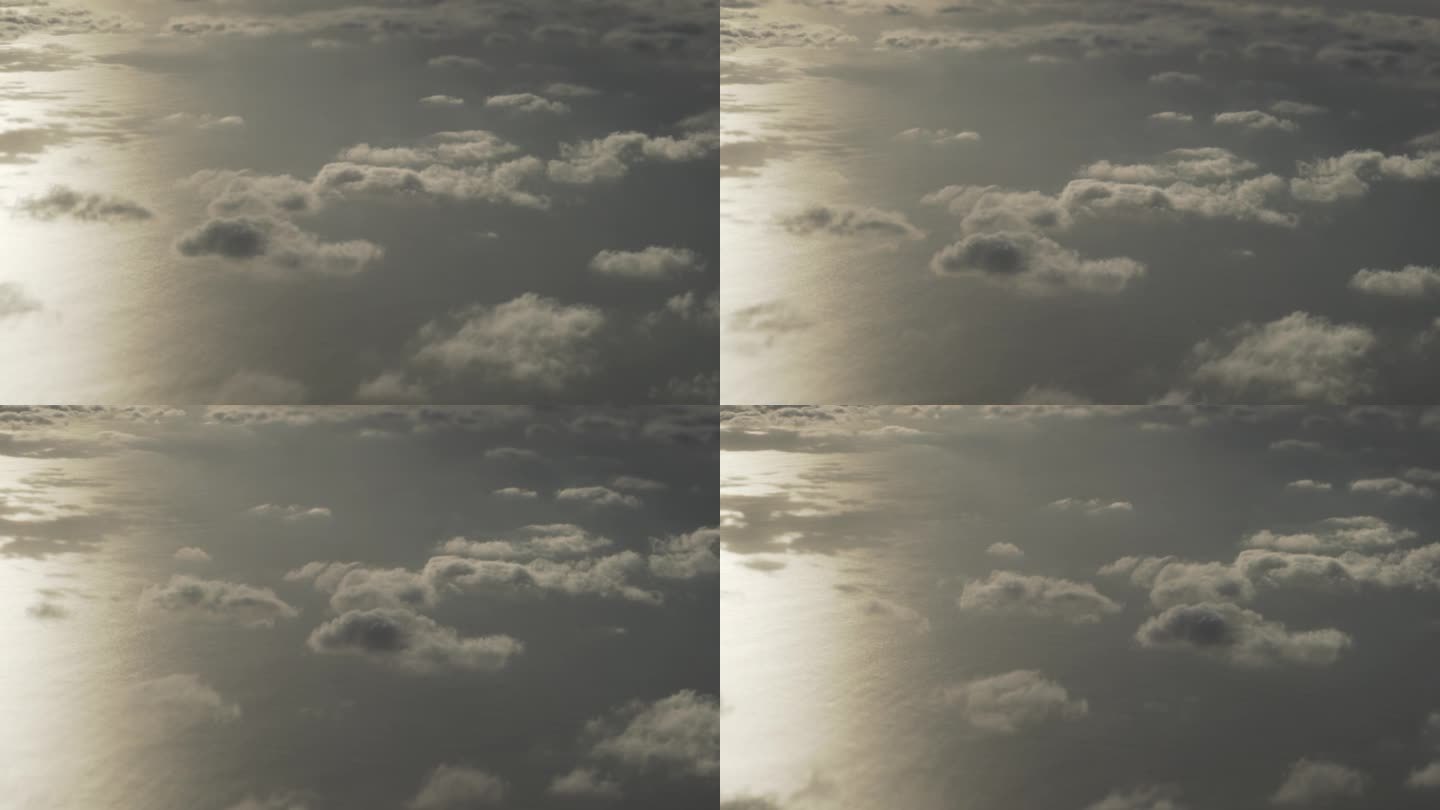 从飞机窗口看晨景，在云层之上飞翔