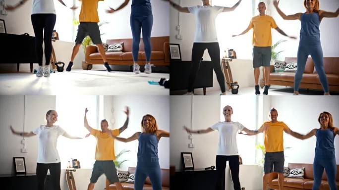 慢动作健身年轻朋友一起做开合跳，享受在客厅的家庭锻炼。活力，运动，锻炼，健康的生活方式，积极的生活方