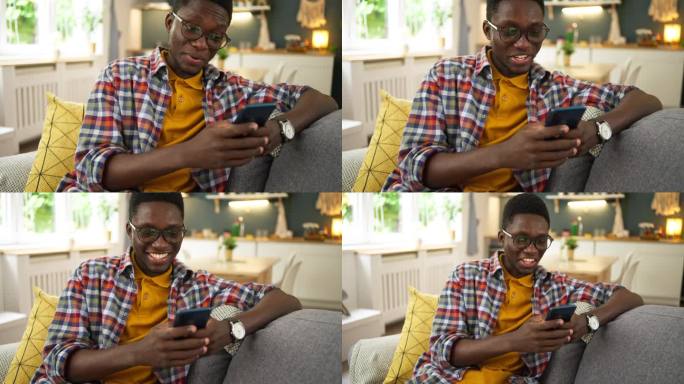 年轻的非洲裔美国人在家使用手机