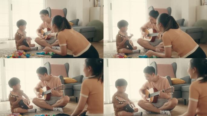 家庭学习:亚洲父子在音乐中寻找快乐，微笑着弹吉他。