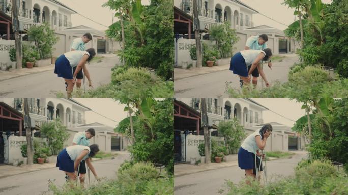 快乐的亚洲残疾夫妇在他们的花园一起拥抱自然。园艺幸福与爱。