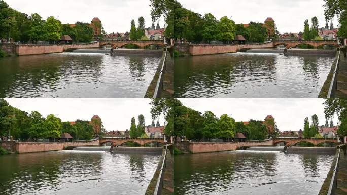 2023年8月1日，德国纽伦堡。沿着河流穿过历史中心的惊人镜头:在有盖的人行天桥后面，可以瞥见历史建