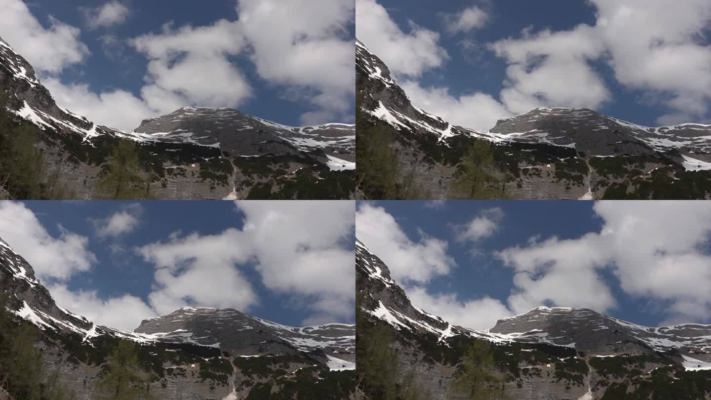 定格画面从雪山与快速流动的白云