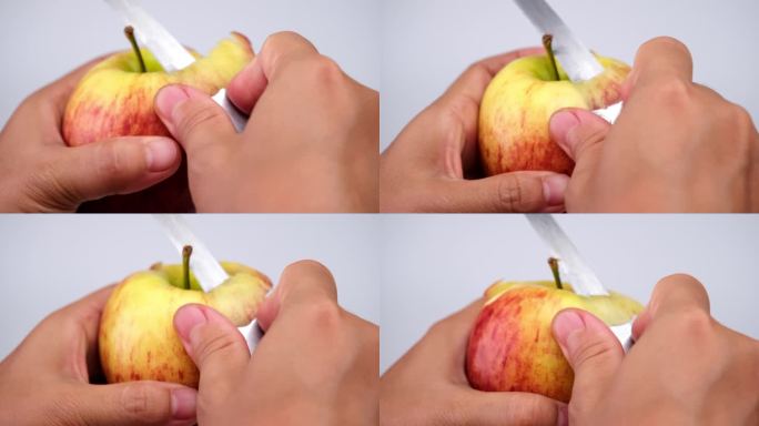 用刀近距离用手削苹果皮。在厨房里剥红苹果的女人。