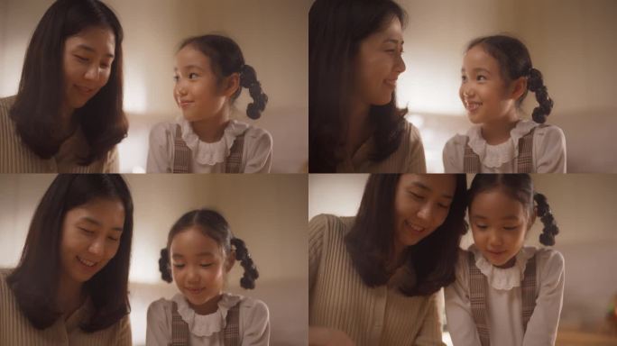 厨房里:韩国妈妈和可爱的小女儿一起做健康晚餐。妈妈教小女孩健康的习惯和如何切蔬菜做沙拉。可爱的孩子帮