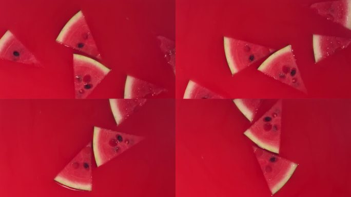 新鲜西瓜片落入红色果汁漩涡的超级慢动作镜头
