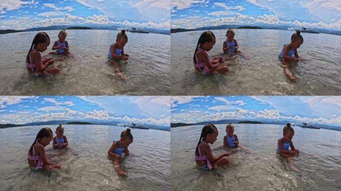 三姐妹的孩子们在海滩和浅水里玩耍