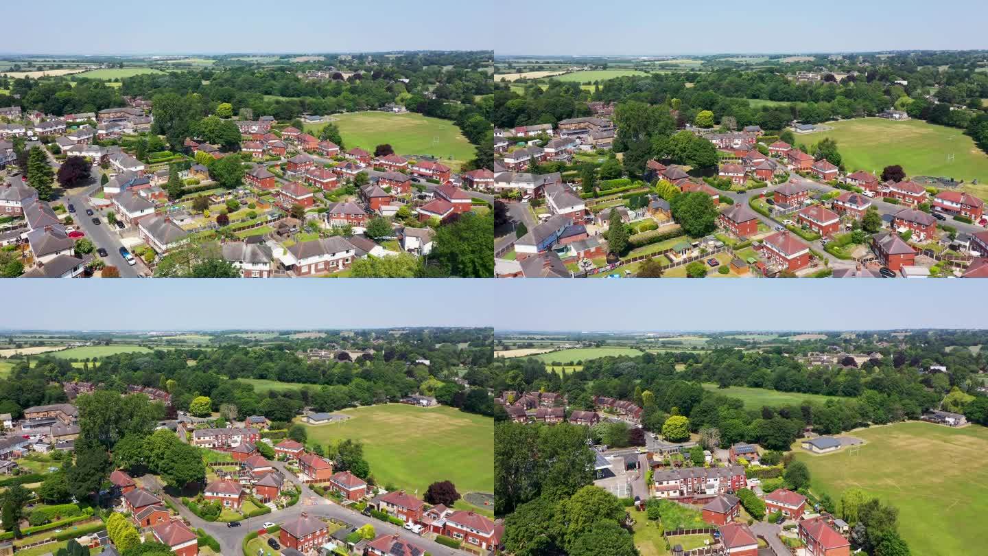 这是英国西约克郡韦克菲尔德市美丽的海姆斯沃斯小镇的航拍画面，展示了一个炎热的夏日里小镇周围的住宅区