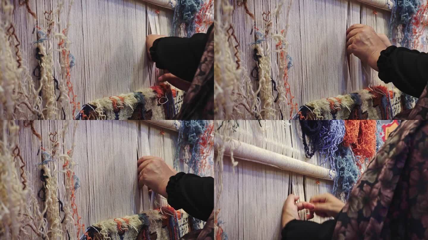 一名妇女编织传统手工地毯