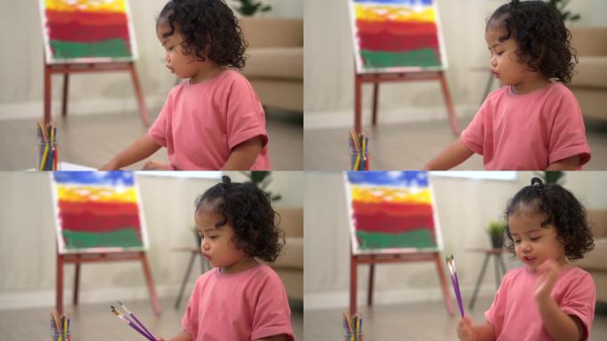 可爱的小女孩在家里的客厅里用画笔创作和画水彩画。孩子们的活动。儿童身体、情感、认知发展的概念。