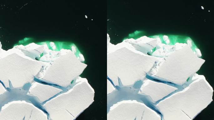 垂直镜头巨大的冰山与雪堆在南极的南极海洋。