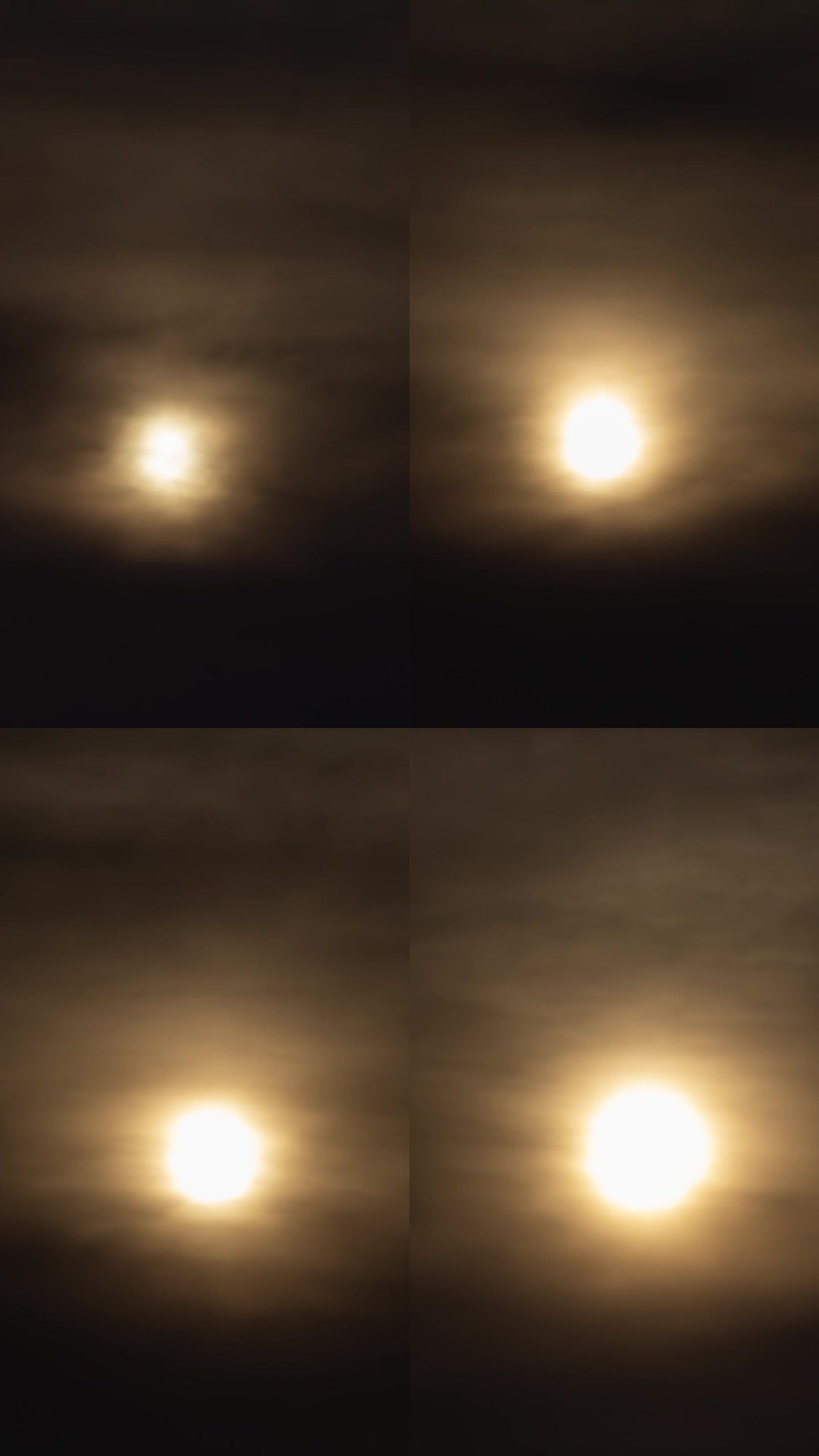 满月在夜晚破云而出。间隔拍摄。