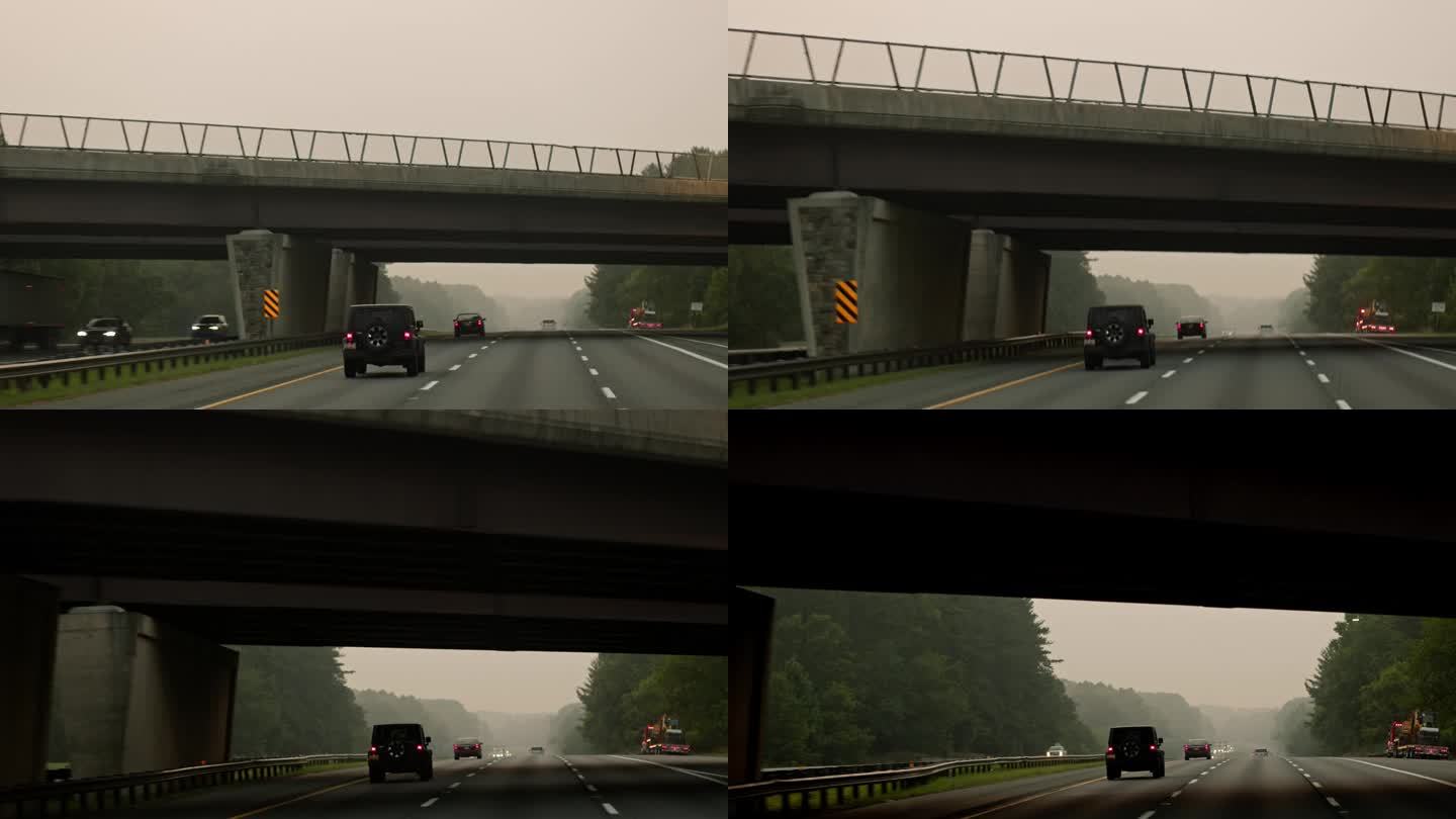 烟雾弥漫的马里兰州公路之旅:汽车在烟雾弥漫的道路上从桥下经过。POV汽车驾驶