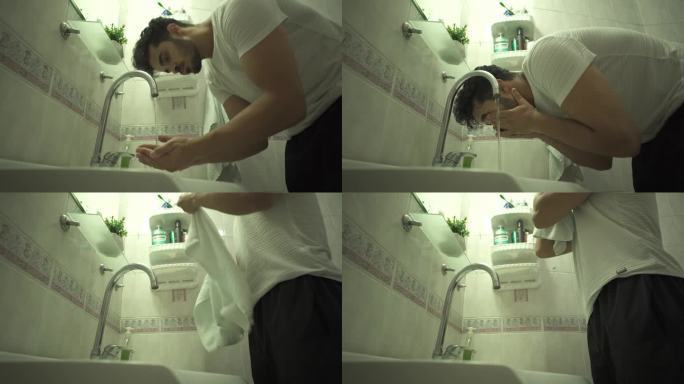 单身男子在浴室洗脸，用毛巾擦拭