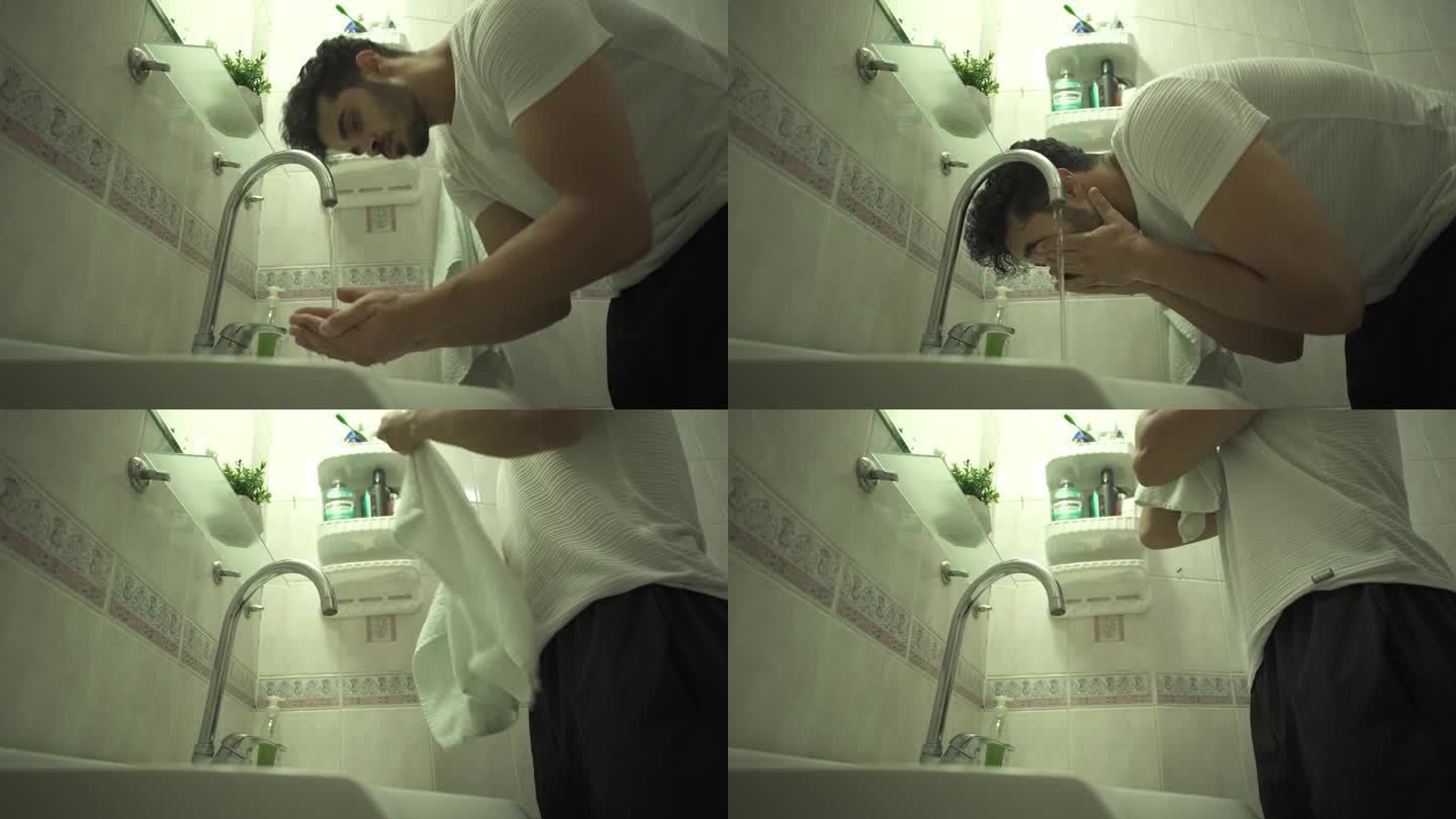 单身男子在浴室洗脸，用毛巾擦拭