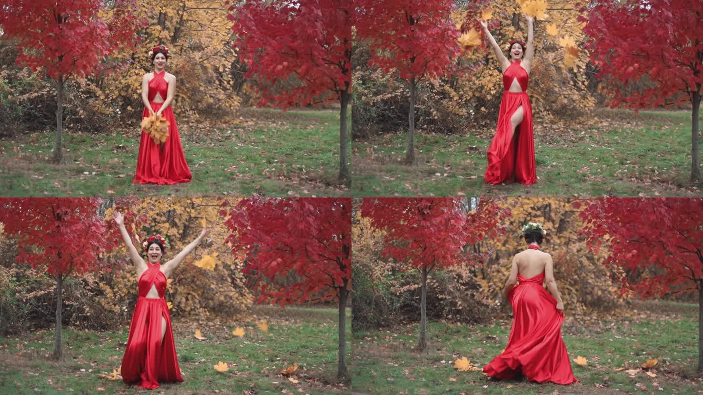 一位女士身穿红裙子，头上戴着花环，抛撒着树叶，在秋天快乐。秋天公园里的女孩。