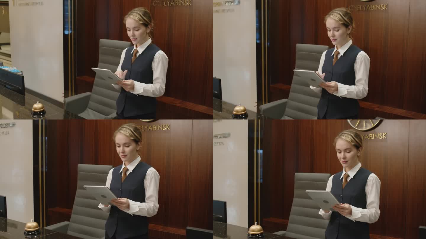 女制服管理员在酒店使用数码平板电脑