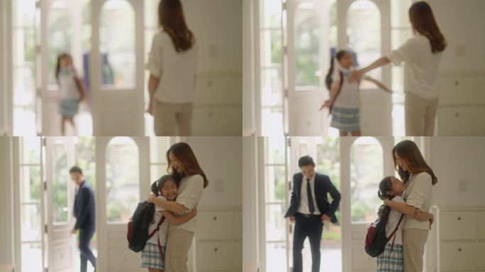 小女孩早上抱着妈妈离开家去上学，说再见。亚洲家庭准备在女儿上学的第一天去学校。