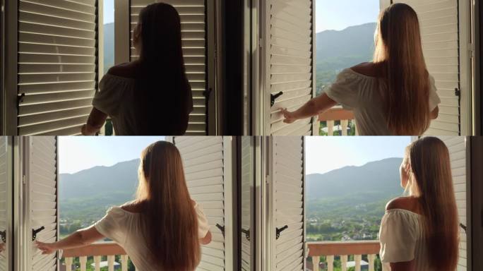穿着长裙的年轻女子优雅地打开阳台门，走上露台，拥抱迷人的山日出或日落，一个夏日假期和自然美景的视觉故