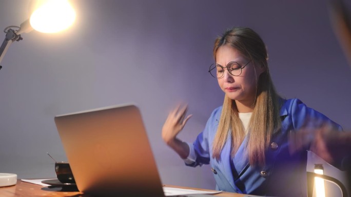 工作过度疲劳的年轻亚洲女性，在电脑工作后感到头痛，办公室综合症和伸展。压力大的成年女商人