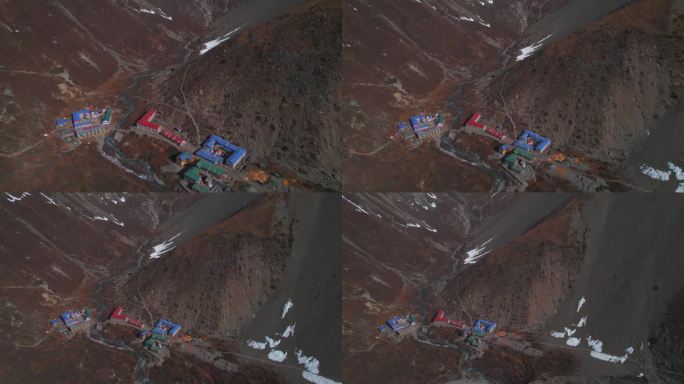 从空中俯瞰喜马拉雅山脉的红蓝色屋顶房屋。在提里科大本营徒步旅行。住宿、宾馆建筑、旅游理念。