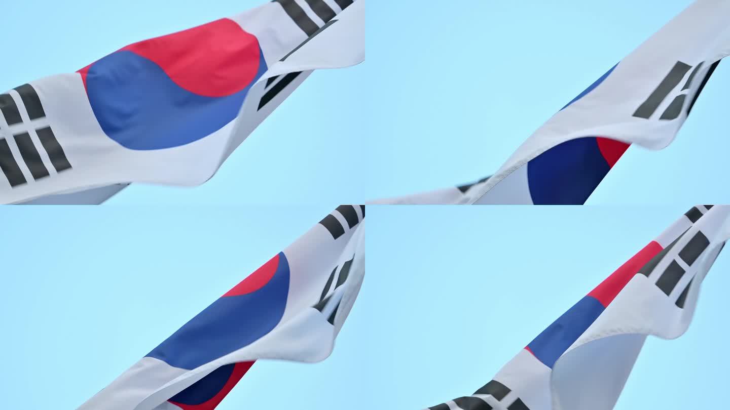 韩国国旗太极旗的特写，在晴朗的夏日天空中迎风飘扬。