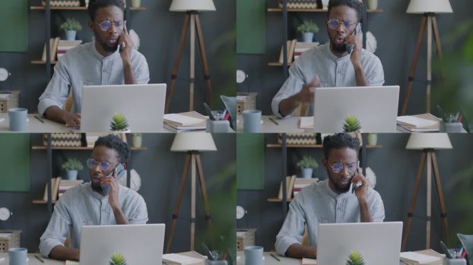 在办公室工作的非洲裔美国人一边打电话，一边在笔记本电脑屏幕上查看信息