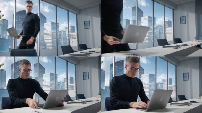 白人商人站在角落办公室里，拿着笔记本电脑在大窗户前，可以看到大都市的城市景观。职业CEO坐在办公桌前