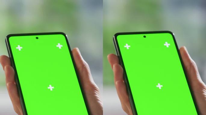 垂直屏幕:顶部视图匿名女性使用智能手机模拟绿屏Chromakey显示与运动跟踪占位符。女人在家里查看