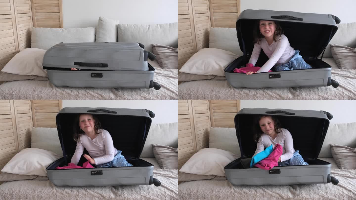 一个七岁的小女孩藏在一个大行李箱里，想吓唬吓唬人，突然从行李箱里爬了出来。