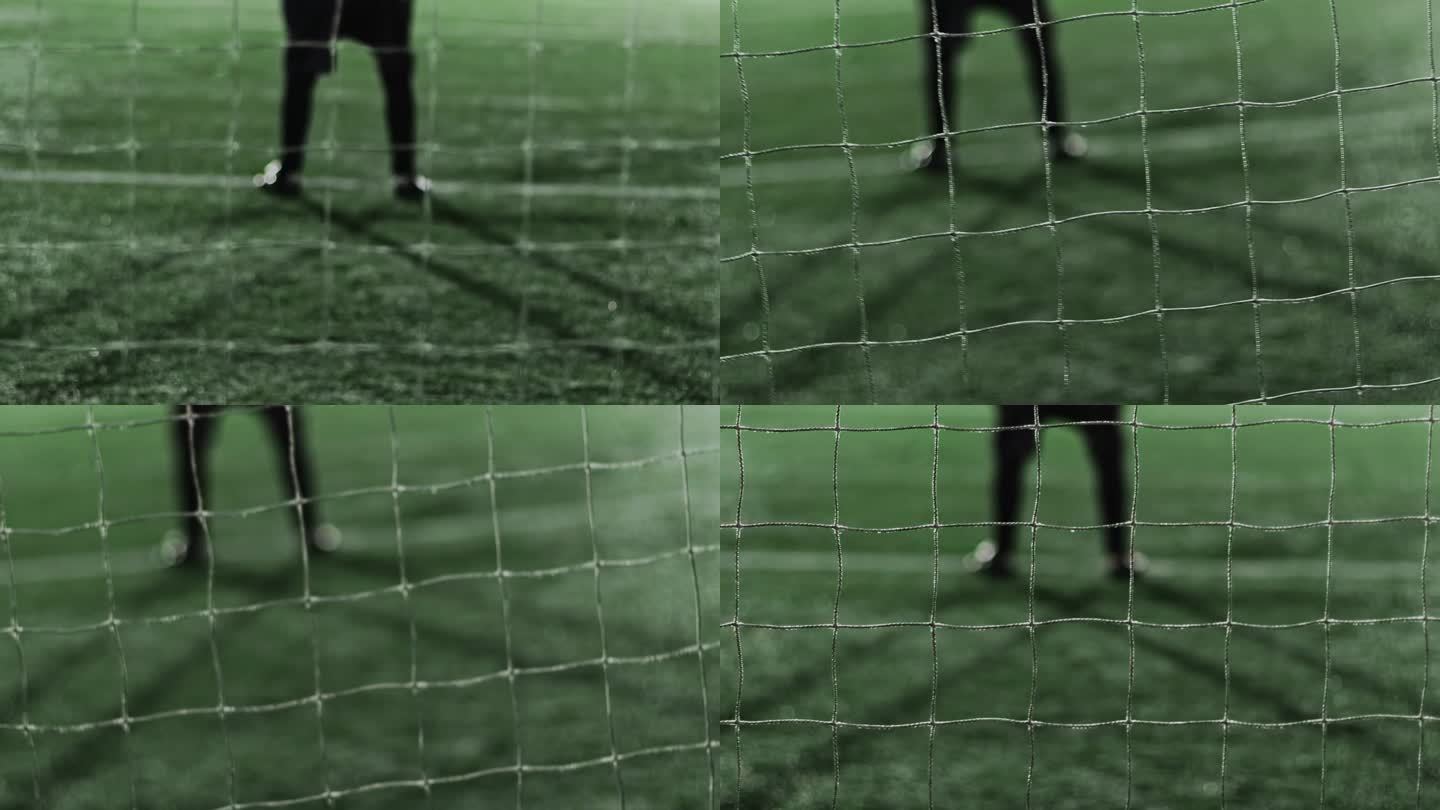 在晚上的足球比赛中，守门员的双腿站在球门上。专注足球网。摇晃的手持镜头