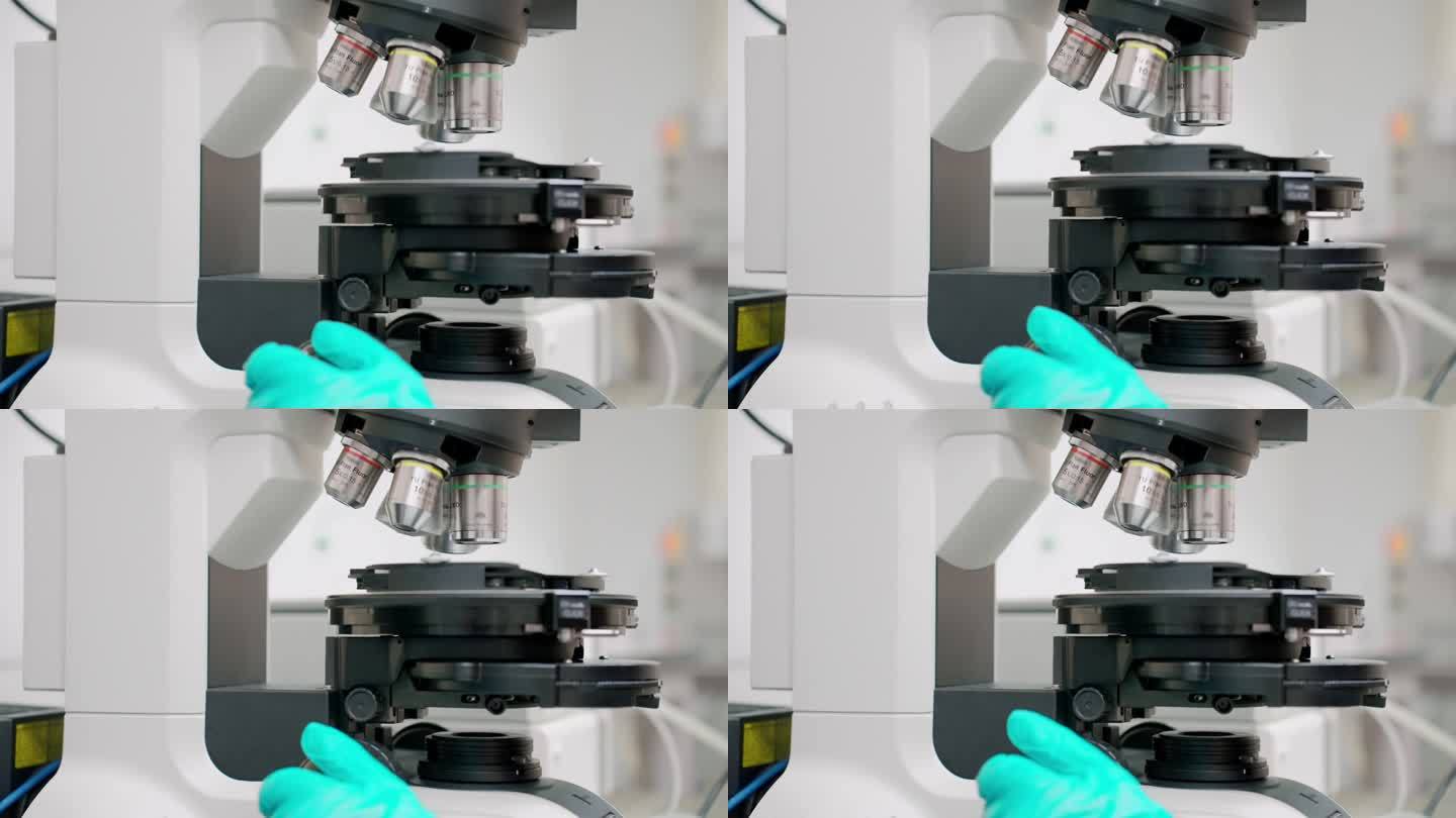 科学家戴着防护手套使用光学显微镜