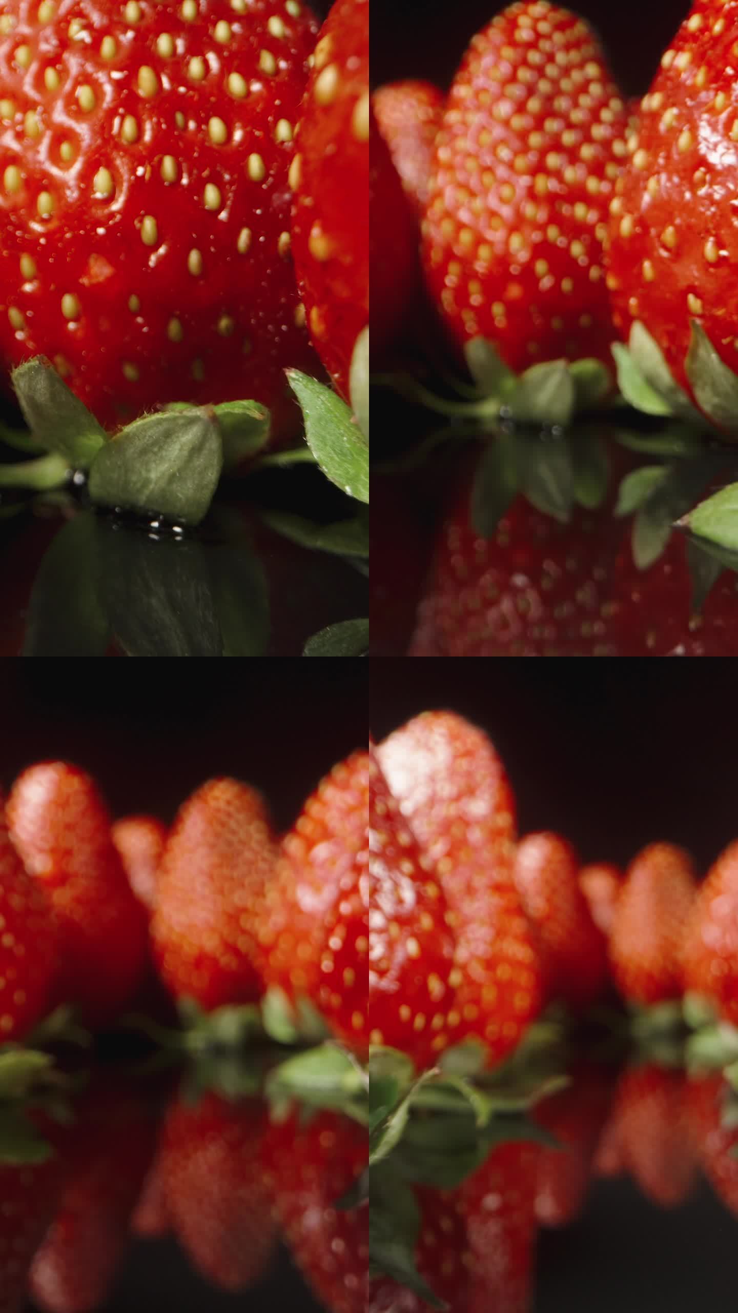 多汁的草莓整齐地摆放在带镜子的黑桌子上。多莉滑块极端特写。垂直视频。