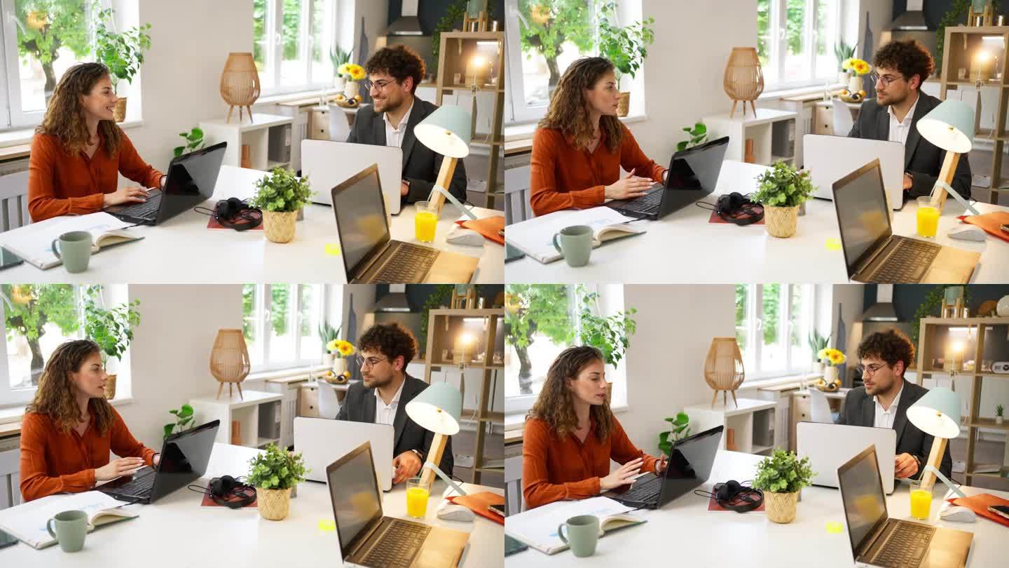 白人女性和男性同事在现代家庭办公室一起工作