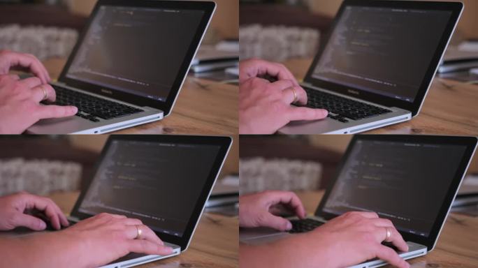 戴着婚戒的男性双手正在木桌上的笔记本电脑上打字