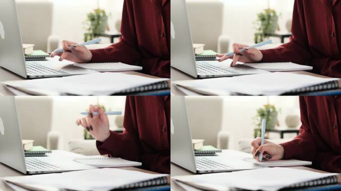 少女的手使用笔记本电脑和记笔记