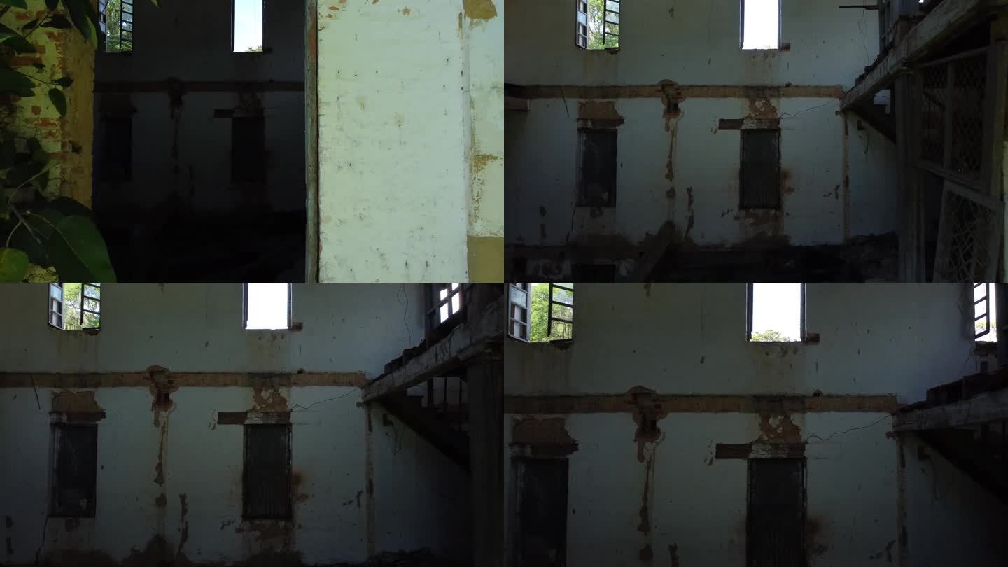 摄像机靠近破旧建筑的大窗户，打开的窗户里长着腐烂的藤蔓，航拍视频
