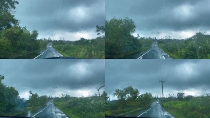 大雨下，行驶在毛里求斯岛内陆公路上的右手驾车。司机在车内观看4K视频。