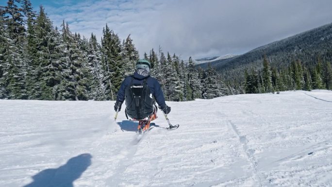 Adaptive athlete skiing down mountain