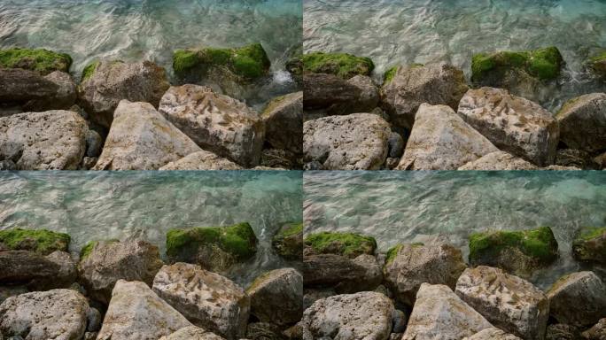 大海之美，这令人惊叹的慢动作镜头，海浪冲刷着岩石，上面生长着海藻和藻类