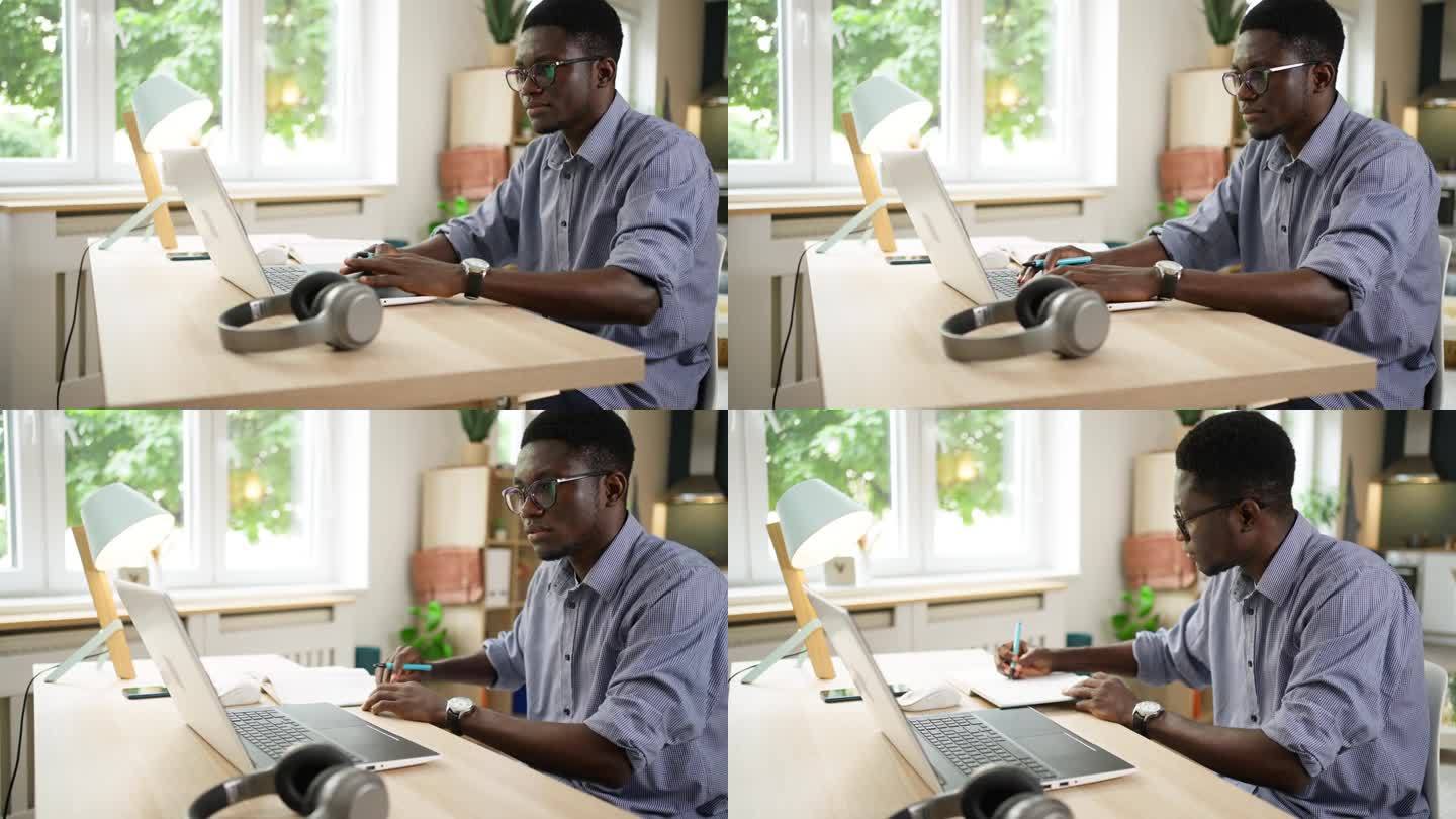 非裔美国男性学生在使用笔记本电脑时进行电子学习