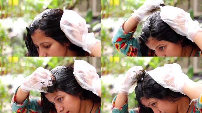 女性在头发上涂抹曼海蒂(自然护发)